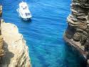 Cruise boat next to rock formation